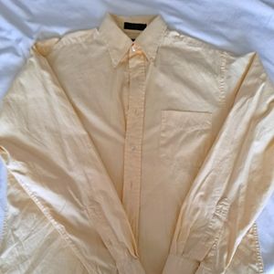 Warm yellow button down shirt.